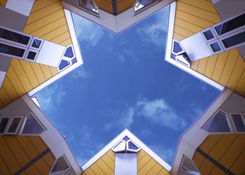 Low angle view of modern buildings against blue sky