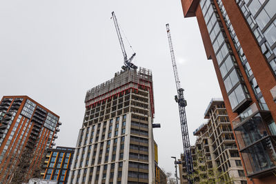 Urban construction site with multiple high rise buildings and tower cranes. london, uk, 6 april 2024