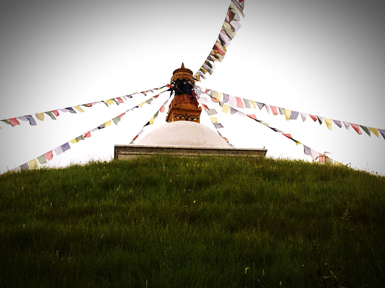 religion, spirituality, place of worship, clear sky, built structure, temple - building, architecture, low angle view, building exterior, cross, grass, sky, day, cultures, outdoors, no people, tradition, church