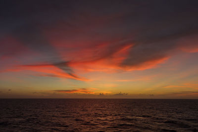 Scenic view of sea against romantic sky at sunset