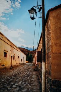 Empty alley amidst buildings in city