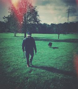 People walking on grassy field