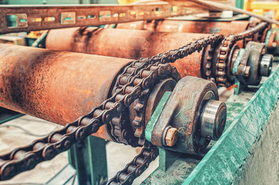 Corroded parts of old broken transmission close-up. rusty metal chain, transmission shafts.