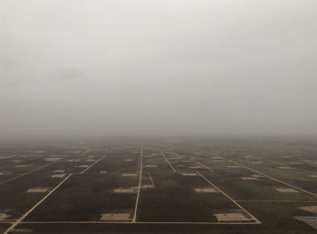 Airplane on runway against sky