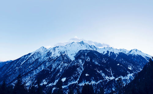 Scenic view of snowcapped mountains against clear sky