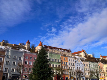 Low angle view of buildings against blue sky