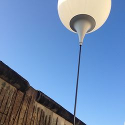 Low angle view of street light against clear blue sky