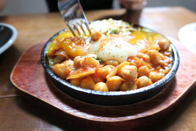 Close-up of chick-pea served with egg yolk on plate