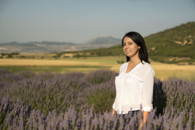 Portrait of smiling woman standing on field