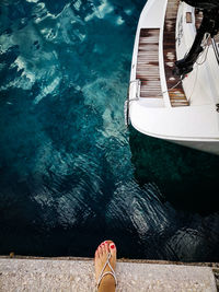 Low section of woman standing on pier over sea