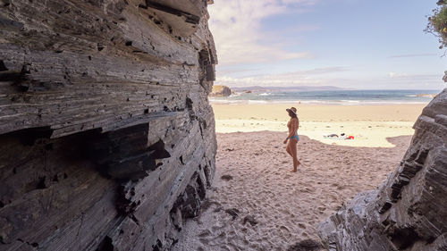 Woman on beach against sky