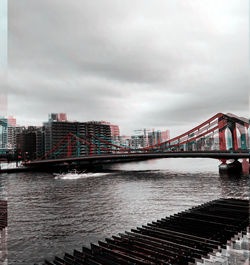 Bridge over river with buildings in background