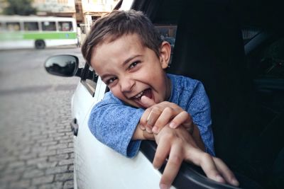 Close-up portrait of boy in car