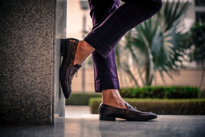 Low section of woman standing on street