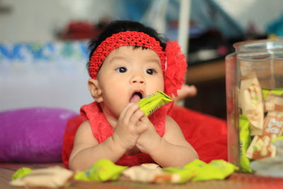 Portrait of cute baby girl eating food