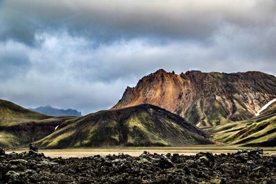 Scenic view of mountains against cloudy sky