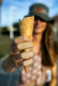 Midsection of woman holding ice cream