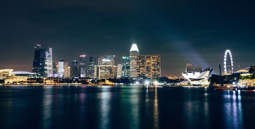 Illuminated city at waterfront