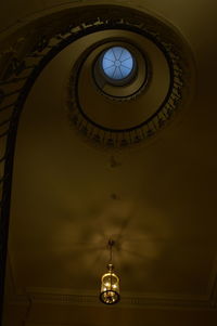 Low angle view of illuminated electric lamp on building