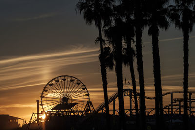 Silhouette ferris wheel against sky at night