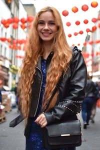 Portrait of smiling young woman standing outdoors