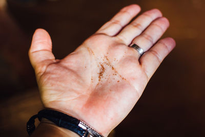 Cropped hand holding tobacco seed