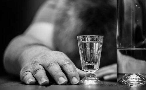 Close-up of man hand by drink