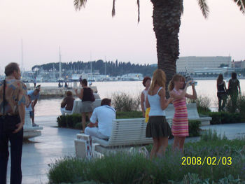 People relaxing at lakeshore