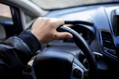 Cropped image of man driving car