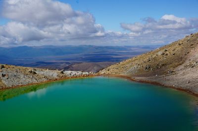 Scenic view of volcanic lake against sky