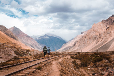 Rear view of person walking on road