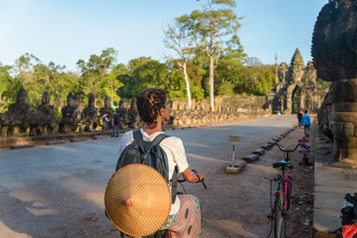 Rear view of man sitting on bicycle against sky