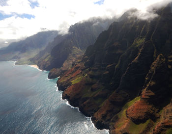 Scenic view of sea and mountains against sky