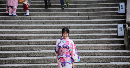 Woman with umbrella on steps