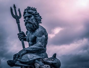 Low angle view of statue against cloudy sky