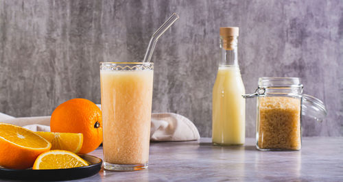 Vegetarian smoothie made from rice milk and orange in a glass on the table web banner