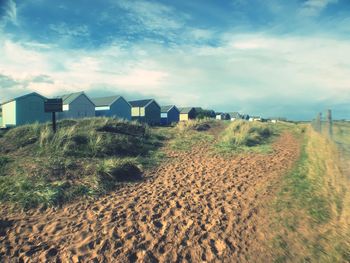 Houses on beach against sky