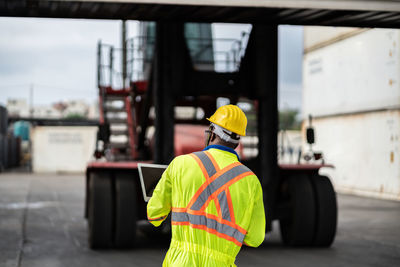 Rear view of man working at bus