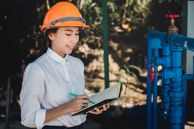 Side view of woman wearing hardhat