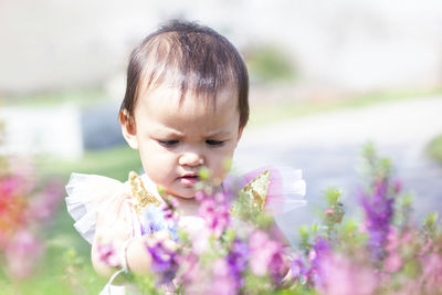 Close-up of cute girl with purple flowering plants