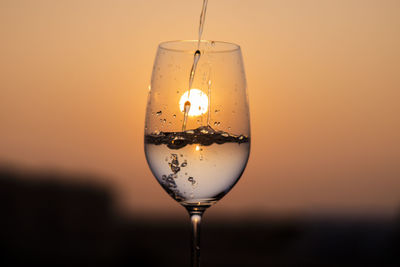 Close-up of wineglass against yellow background