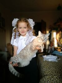 Portrait of girl with cat at home