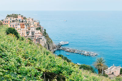 High angle view of townscape by sea against sky