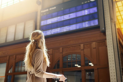 Woman standing by window