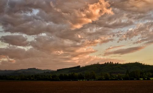 Scenic view of landscape against cloudy sky