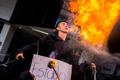 Full length of man holding fire at night