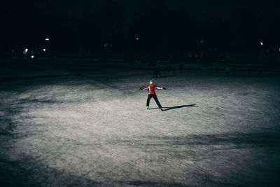 Full length of man on snowy field at night