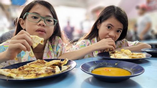 Portrait of smiling woman having food