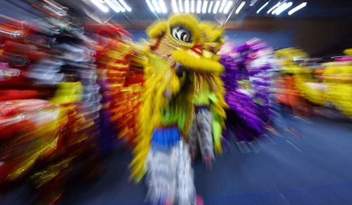Blurred motion of woman on multi colored background