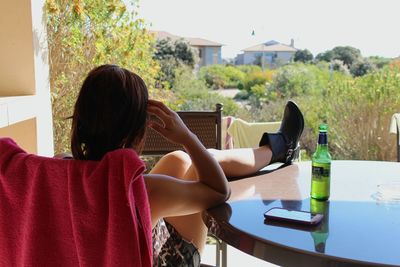 Rear view of woman sitting on bench